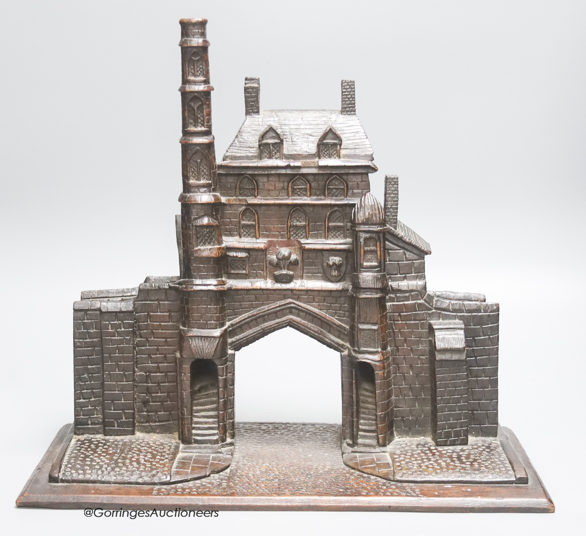 A 19th century carved oak model of a medieval Gatehouse, stamped A. Cotgreave, and inscribed 1774, width 37cm height 34cm